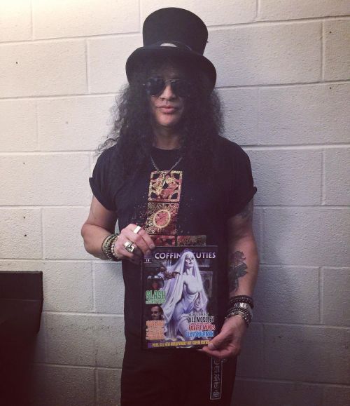 @slash holding a copy of @coffincutiesmagazine he’s featured in. ☠️⚡️⚰️ coffincuties.com #coff