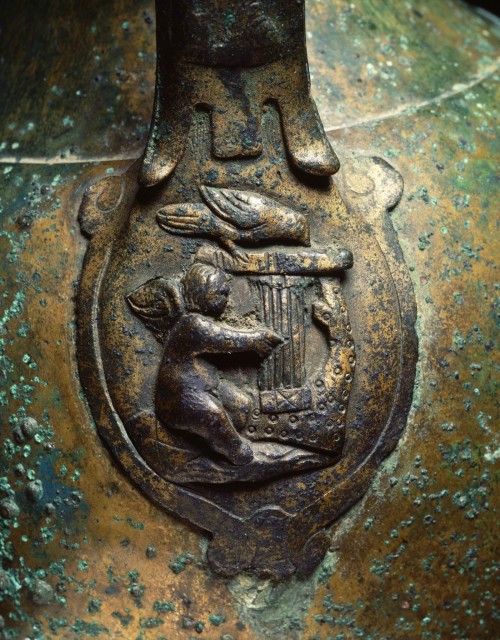 romegreeceart:A detail of the Roman bronze vase -  Amor is playing a lyre23,7 cm, NetherlandsPh