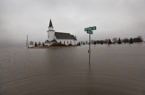 A rural church is surrounded by flood water, April 10, 2011, near Gardner, North Dakota.&gt; Photos: