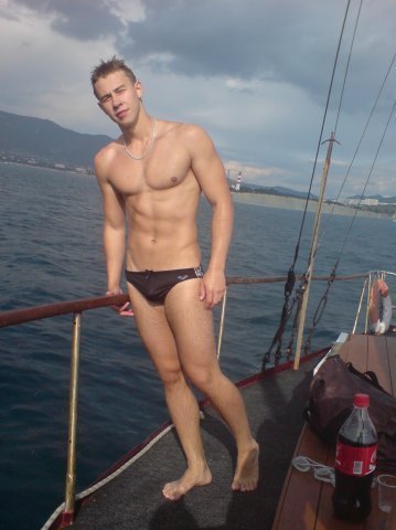 speedoclassics:  Lean and fit in a low-cut black speedo aboard a sail boat.