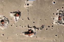 Palestinian children look out from their