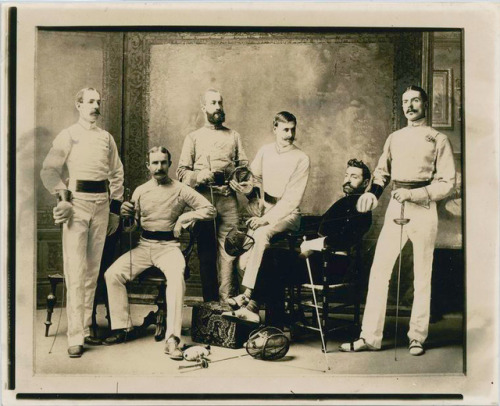 [ID: several men in old-fashioned fencing uniform, holding foils or masks.] Group of New York fencer