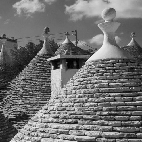 The Cone-shaped Roofs Of Alberobello's Trulli In Puglia, Italy. Derived From The Greek Word Τρούλος