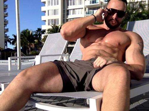Looks like he is absentmindedly stroking himself while on the phone.