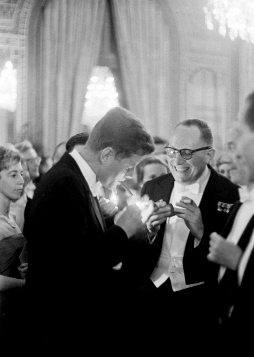 jfk-and-jackie: JFK lights up a cigarette at an unknown event.