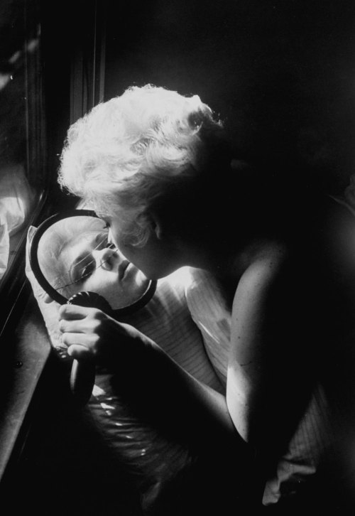 Kim Novak looking into a broken mirror, 1956. Photograph by Leonard McCombe.