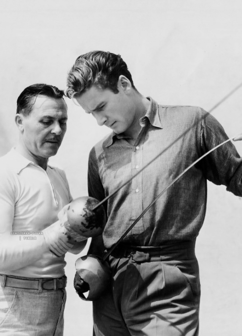 gentleman-flynn: Fred Cavens, Belgian fencing master, teaches Errol Flynn how to use the sword on th