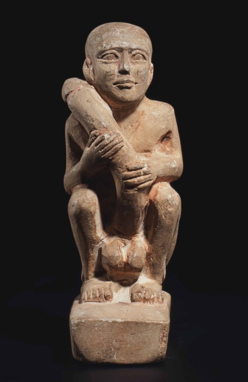 Egyptian Limestone Eroticon of MaleThis nude male figure squatting on an integral rectangular plinth