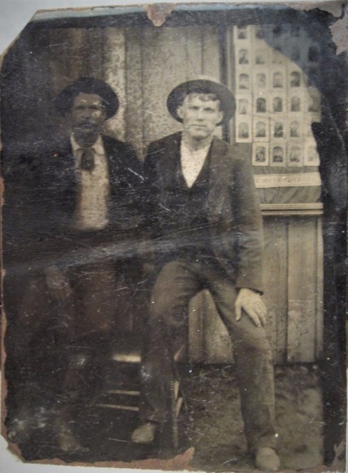 Outdoor studio with display of tintypes in paper frames