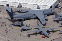 militaryarmament:  The C-5 Galaxy next to a C-130 Hercules and a couple of fighters. Still blows my mind how big the C-5 Galaxy really is…  Whattttttttttt