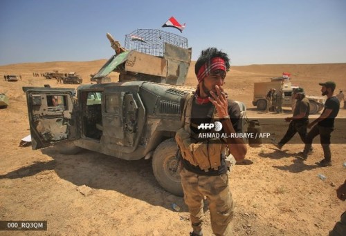Shiite fighters from the Popular Mobilization Forces advance towards   the city of Tal Afar, th
