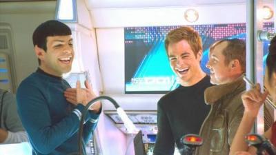 Photo from the set of one of the 2009 Star Trek series movies with the actors for Spock (Zhackary Quinto) and Kirk (Chris Pine) dressed in character and laughing with wide smiles