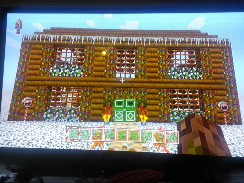 Shitty quality pictures of the Festive Texture pack since I don’t know how to screenshot on the Xbox One. The lollipops and wreaths and the icicles on the roof are paintings! And instead of vines, there’s lights hanging from the trees!