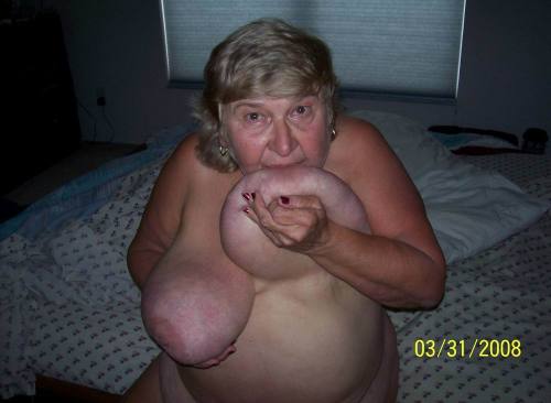 XXX Granny sucking on her huge breasts while photo
