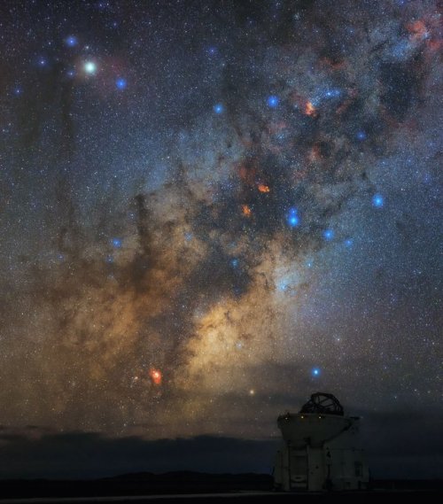 Bright blue stars scatter the sky over the Paranal Observatory in Chile as the spectacular central r