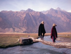 Bojrk:  Two Villagers Traverse A Small Stream In A Valley Of Peru’s Cordillera