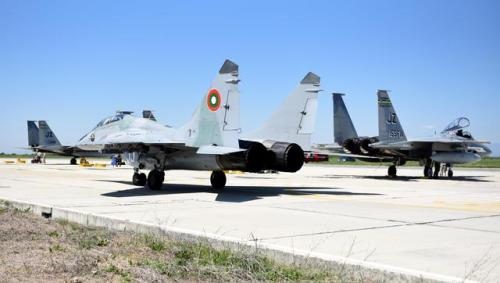 A Bulgarian MiG-29 Fulcrum taxis by American F-15C Eagles in Bulgaria on April 26, 2017. (USAF/TSgt 