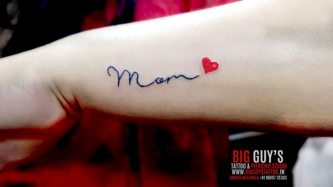 Big Guys tattoo — Mom with small red heart tattoo done at Big Guys...