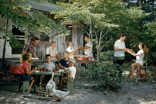 Friends eat watermelon outside a beach cottage on a summer afternoon on Roanoke Island, North Caroli