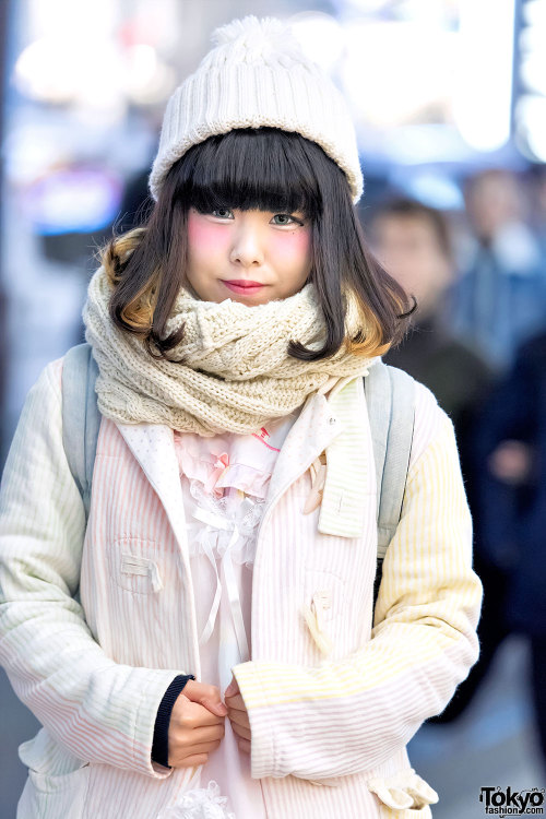 Onachi on the street in Harajuku wearing a pastel striped Keisuke Kanda blazer over a lace and ribbo