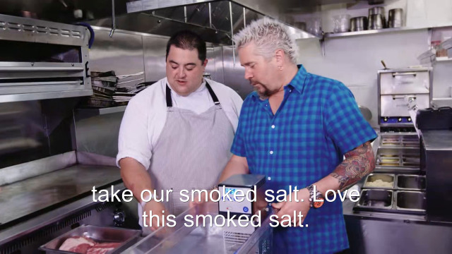 83% sure it's a man cooking in a kitchen preparing food. Caption: take our smoked salt. Love this smoked salt.