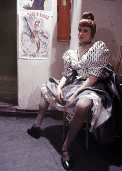 vintageeveryday:  Can-can dancer taking a break at the Moulin Rouge, Paris, 1953. 