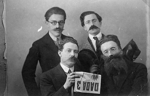 André Breton, René Hilsum, Louis Aragon and Paul Eluard posing with a copy of Dada 3, 1919