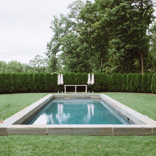 Pool hidden behind large hedges, surrounded by natural grass deck. Elegant simplicity defined. 