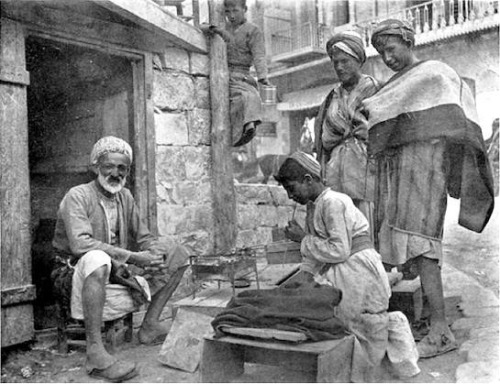 sniper-at-the-gates-of-heaven:a street vendor prepares kebabs for sale, mosul, 1909