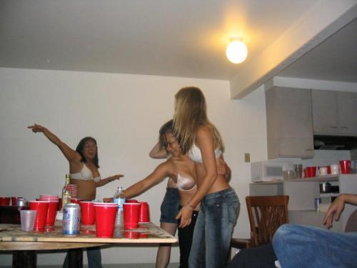 A wonderful embarrassed strip beer pong game, with a large group of cute girls getting down to their