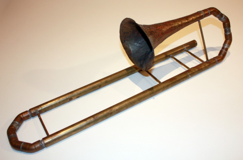 This is a home made slide trumpet, measuring about 2 ft long when contracted. It was meant to be tuned to B flat, but it wound up being tuned to C. I made this in high school as a side project, so the construction is sturdy, but unsightly. That said,