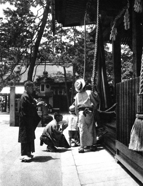 Tokyo, Japan - Whorshippers at the Shinto Shrine. The Japanese origin 神社 (jinja) comes from the term