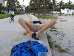 upshortsbabes:  Woman lying on sea wall shows damp spot on shorts …