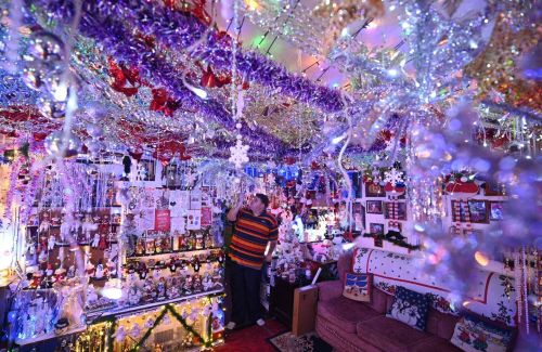 Steven Morton admires the Christmas decorations in his home as he stands in his living room in Hull,