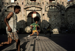 africansouljah:Alex WebbPanama City. 1999. Young men playing soccer in The Old City.