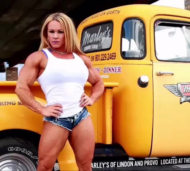 zimbo4444:  ..Aleesha Young..poses her big sweet muscle by a little yellow truck..