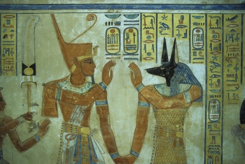 King Ramesses III holding hands with god Duamutef. Detail of a wall painting from the tomb of Amun-h