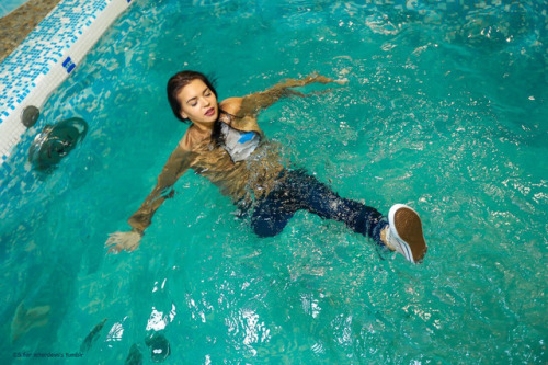 Another amputee girl in pool. Just now she swims in clothes and white converse sneaker