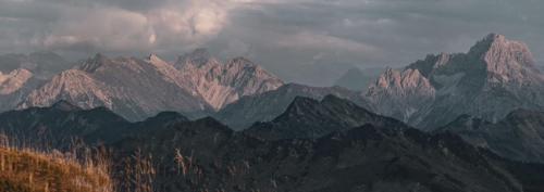 oneshotolive:  Panorama of a mountain range in the sunset light in Vorarlberg, Austria [12650x4570] [OC] 📷: nootcr2 