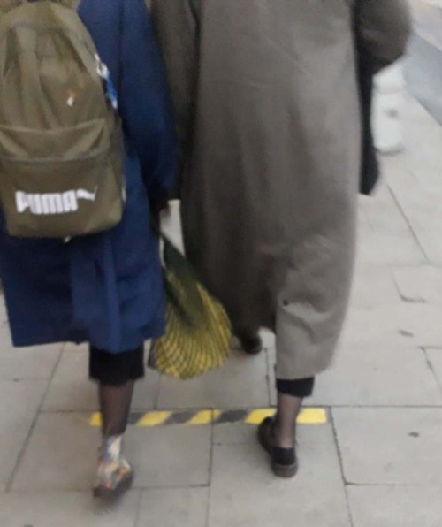 Two girls wear black tights under pants