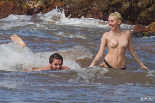 XXX toplessbeachcelebs:Miley CyrusÂ swimming photo