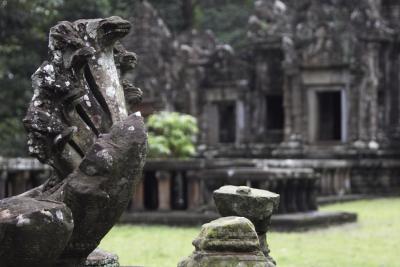 Naga snake mossy stone statue. Angkor Wat temple, Cambodia.