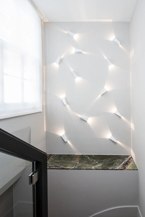 {The stairwell light installation in this apartment by London-based Roselind Wilson Design caught my