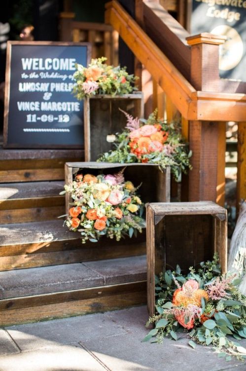 Great use of floral accents and crates to create a welcoming entrance! Maybe add some candles in the evening.