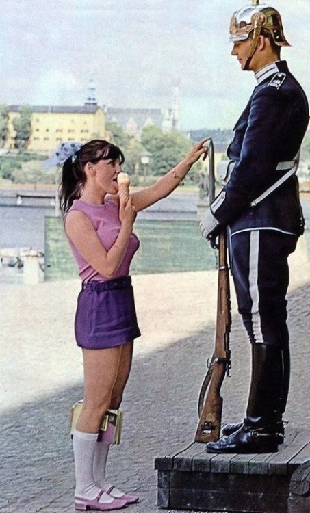 historicaltimes: A girl licks ice cream and plays with the tip of the guns bayonet to try and elici