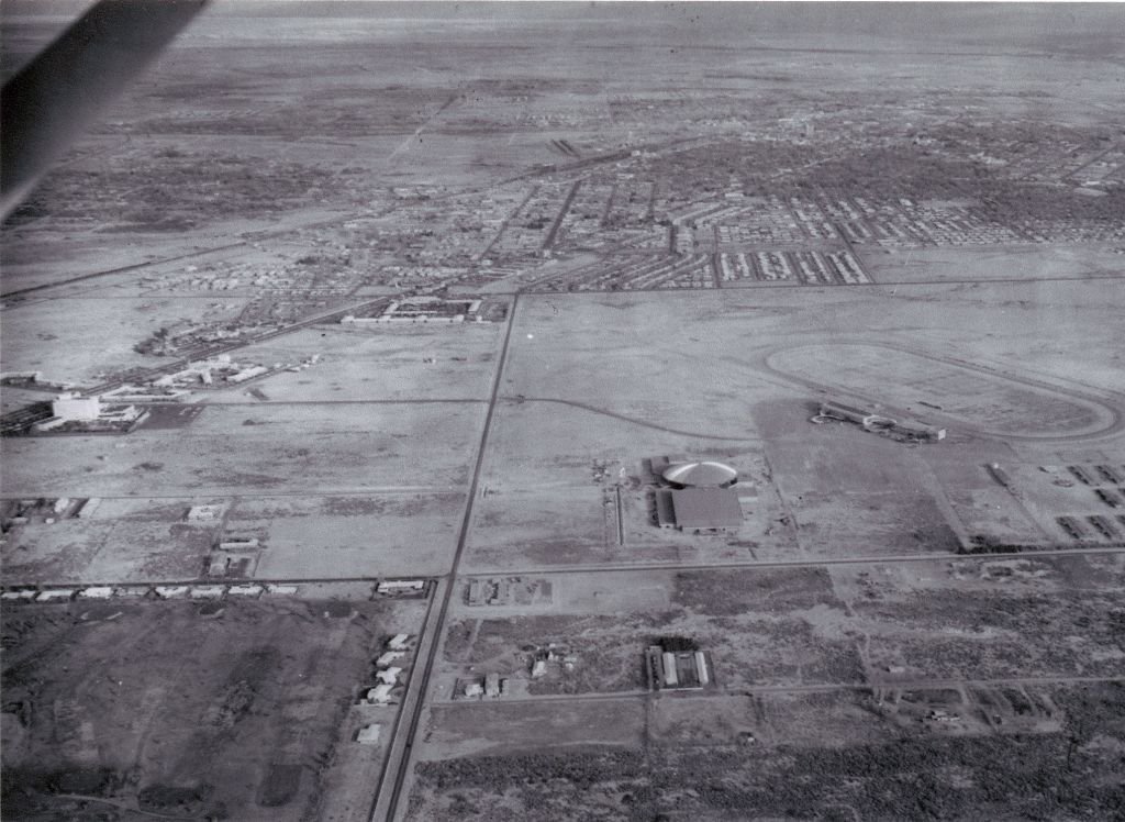 Over Las Vegas, early 1959
Paradise Rd & Desert Inn Rd in the foreground. Homes of the Desert Inn Estates line the perimeter of D.I. golf course. Convention Center (opening 4/12/59) and Las Vegas Park on the right. Joel Rosales Collection, Lost &...