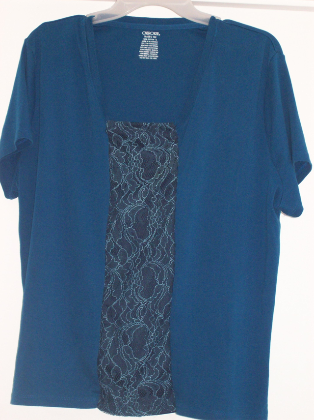 A blue t-shirt with a panel of dark blue lace at the centre front.