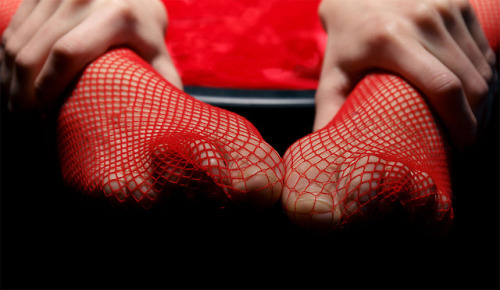 Feet in red fishnets