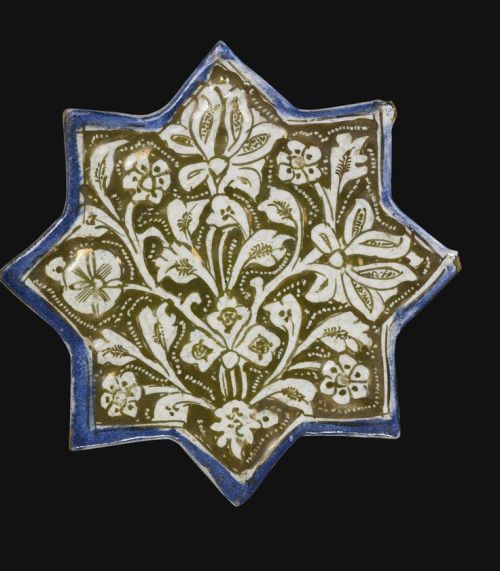 AN ILKHANID LUSTRE STAR TILE, PERSIA, EARLY 14TH CENTURY of eight-pointed stellar form, the fritware