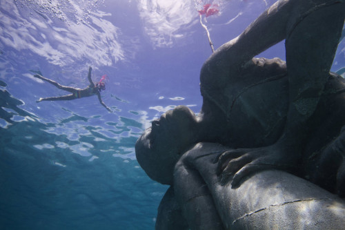sixpenceee:  This 18-foot-tall female Ocean Atlas sculpture can be found off the coast of the Bahamas. It was designed artist Jason deCaires Taylor. It’s part of an underwater museum called MUSA. (Article) 